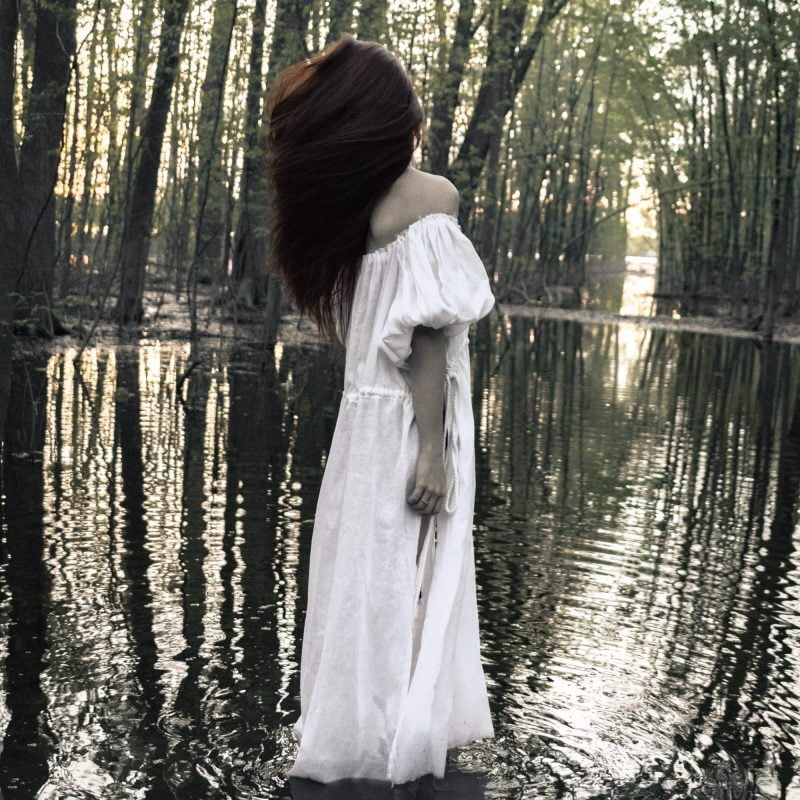 Woman in water wearing white organic dress