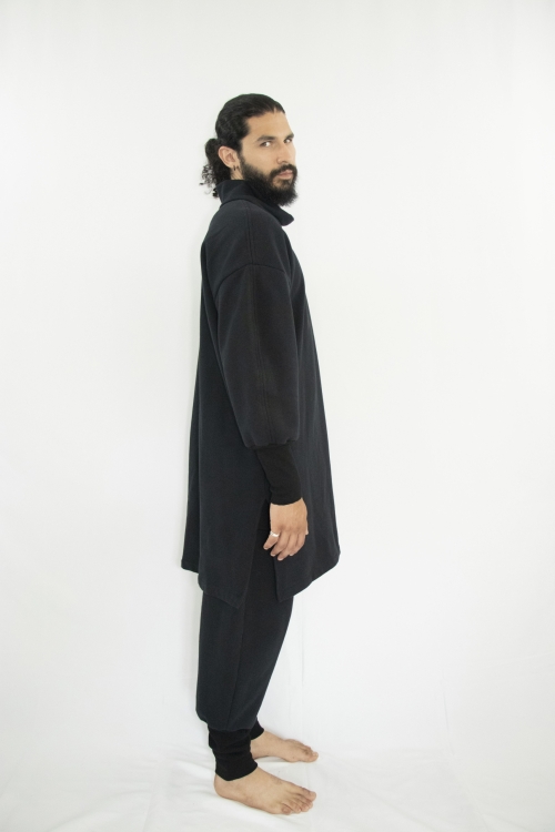 Man wearing organic black unisex tunic with long sleeves and high collar