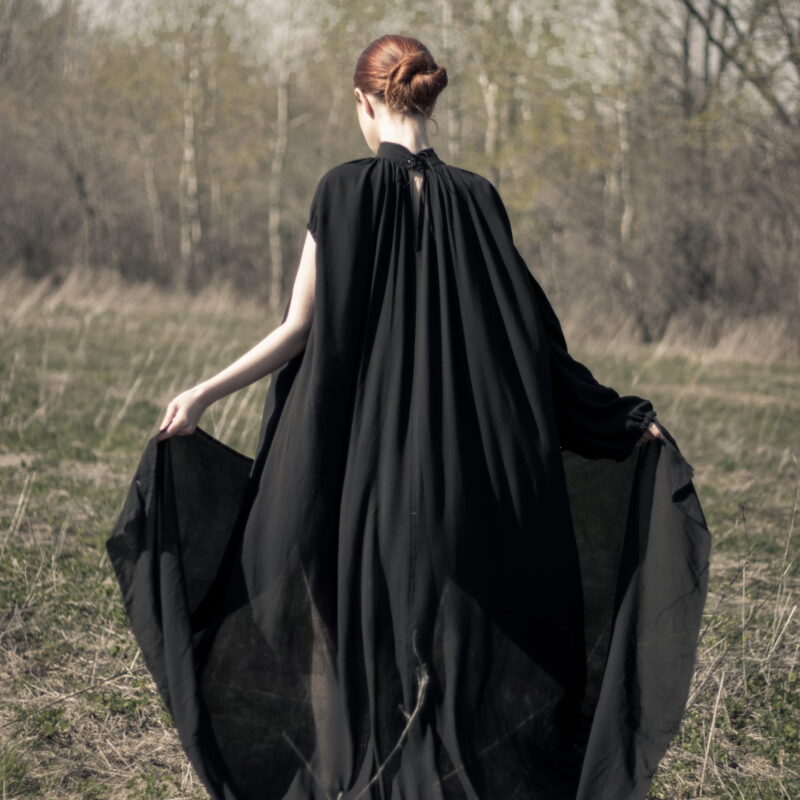 Woman wearing loose black Cearcall dress by Carmen Calburean